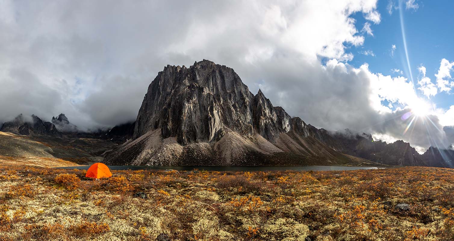 Tent pitched near mountains in Tombstone Territorial Park
